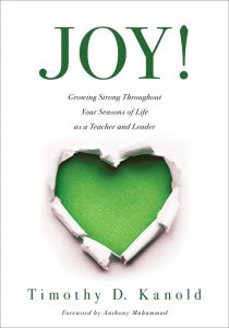 JOY!: Growing Strong Throughout Your Seasons of Life as a Teacher and Leader by Timothy D. Kanold Foreword by Anthony Muhammad, a torn paper effect revealing a green heart shape.